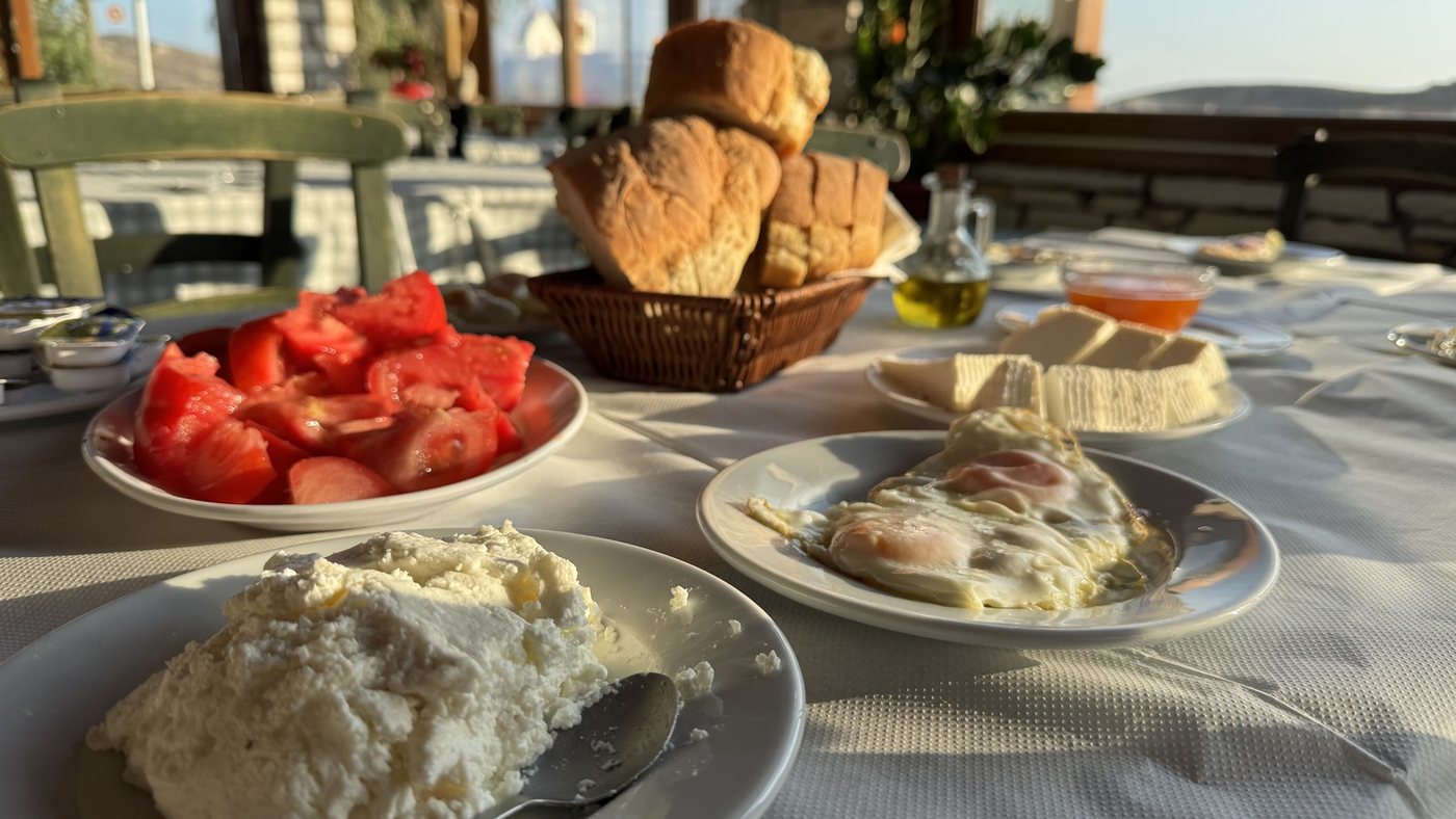Um café da manhã típico de Naxos: queijo fresco, ovos fritos, tomates e pão caseiro